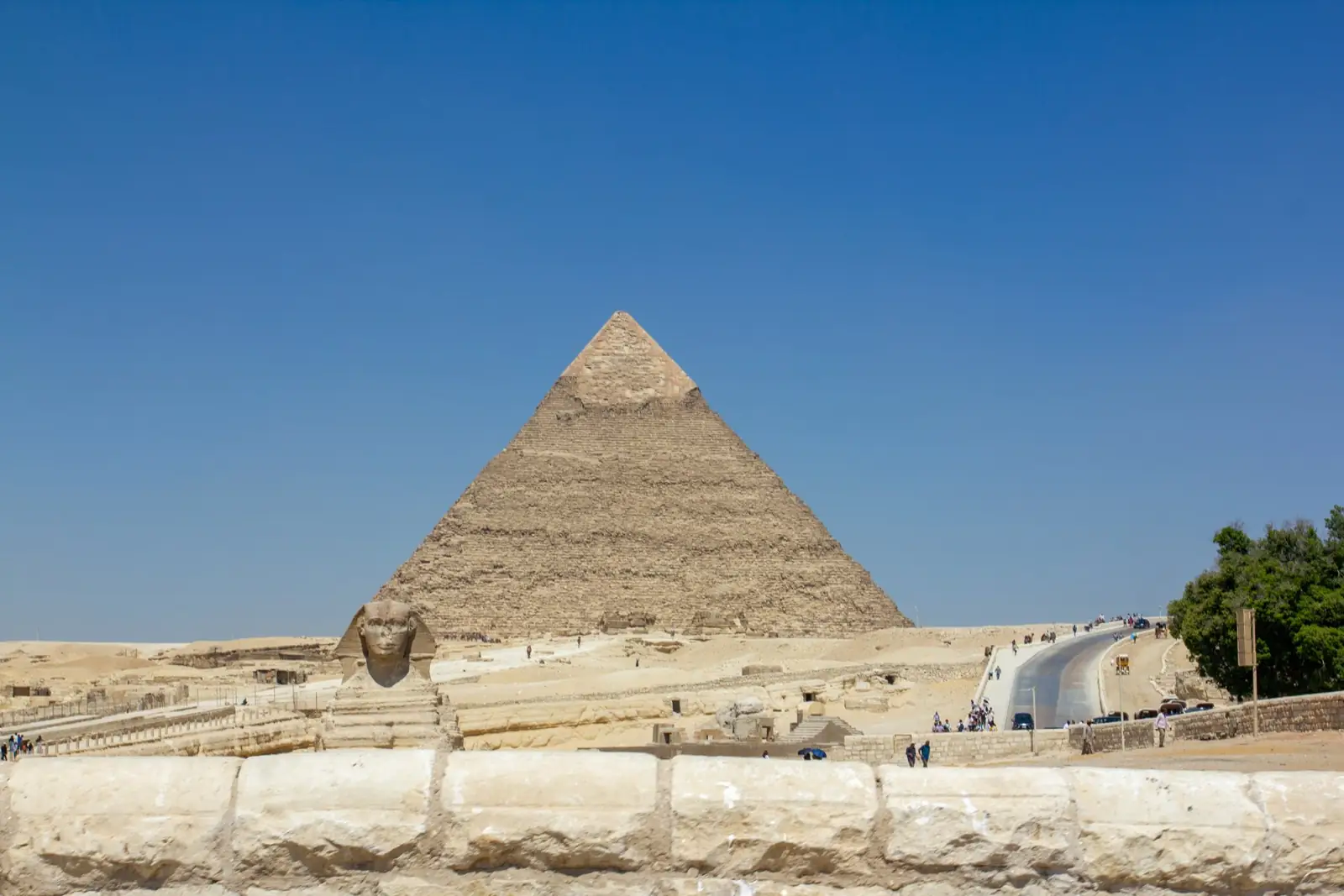 A pyramid and the Sphinx at Giza beneath a clear sky