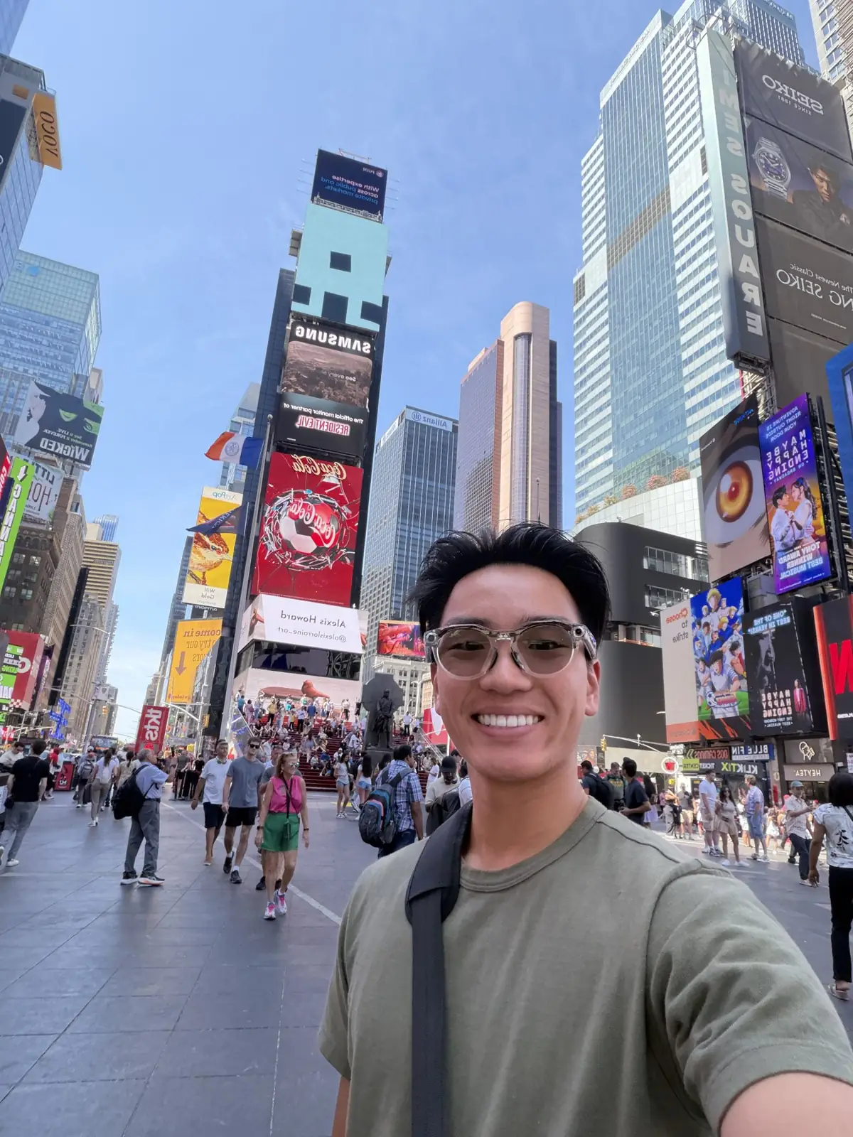 A travel selfie beneath the billboards in Times Square